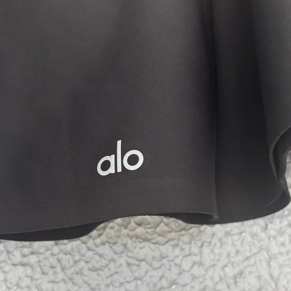 ALO Yoga Airlight Down The Line Black Mini Tennis Skirt with shorts underneath